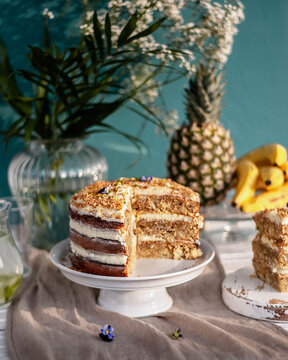 Jamaican Humming bird cake with pine apple banana on a plate against green background