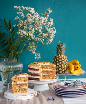Jamaican Humming bird cake with pine apple banana on a plate against green background