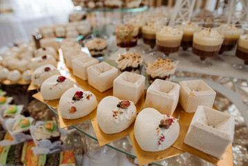 Various desserts and cake on the buffet table at the wedding