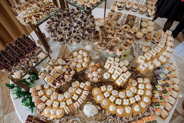 Various desserts and cake on the buffet table at the wedding