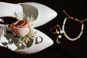 Brides wedding accesories, ring, bouquets and invitation card on flat lay wedding day