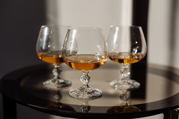 Three glasses with whiskey on the table