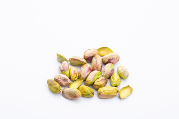 group of roasted peeled pistachios on a white background