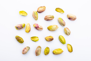 peeled pistachios on white background