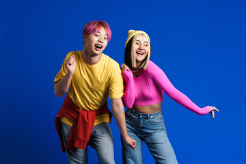 Asian couple with multicolored hair laughing and dancing together