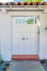 Double wooden white door gate with arbor concrete tile roof at San Francisco, California
