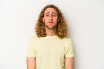 Young caucasian man isolated on white background sad, serious face, feeling miserable and...
