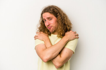 Young caucasian man isolated on white background hugs, smiling carefree and happy.