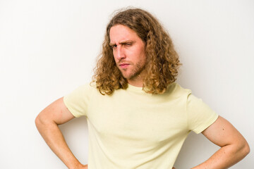Young caucasian man isolated on white background frowning face in displeasure, keeps arms folded.