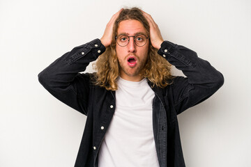 Young caucasian man isolated on white background being shocked, she has remembered important...