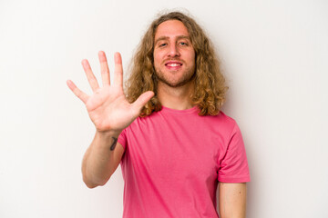 Young caucasian man isolated on white background smiling cheerful showing number five with fingers.