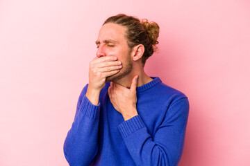 Young caucasian man isolated on pink background suffers pain in throat due a virus or infection.