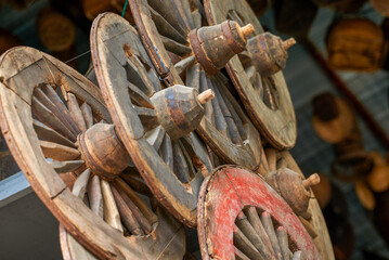 Traditional vintage wooden wheels hanging on the facade wall