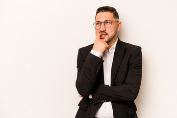Business hispanic man isolated on white background relaxed thinking about something looking at a copy space.