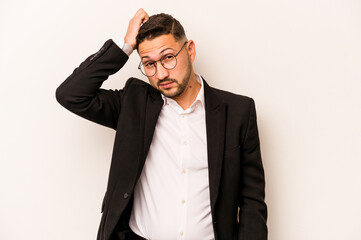 Business hispanic man isolated on white background being shocked, she has remembered important meeting.