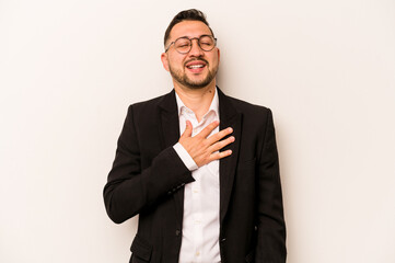 Business hispanic man isolated on white background laughs out loudly keeping hand on chest.