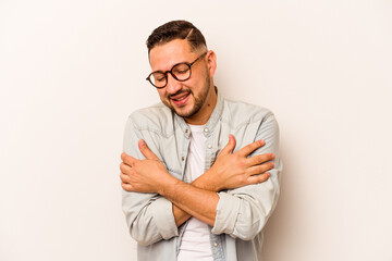 Young hispanic man isolated on white background laughing and having fun.