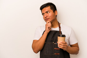 Restaurant hispanic waiter holding a take away coffee isolated on white background looking sideways with doubtful and skeptical expression.