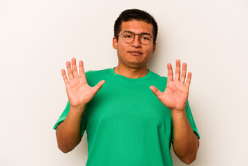 Young hispanic man isolated on white background rejecting someone showing a gesture of disgust.