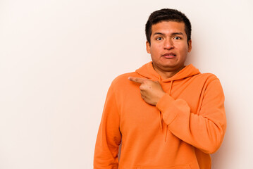 Young hispanic man isolated on white background pointing to the side
