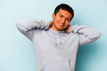 Young hispanic man isolated on blue background stretching arms, relaxed position.