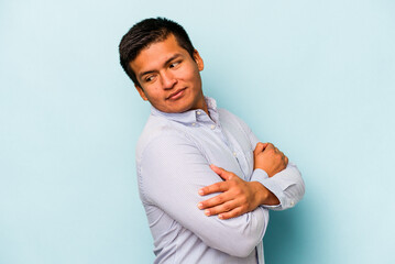 Young hispanic man isolated on blue background laughing and having fun.