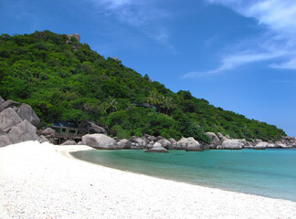 White sand beach, emerald clear andaman sea and bright blue sky