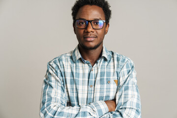 Young black man wearing eyeglasses posing and looking at camera