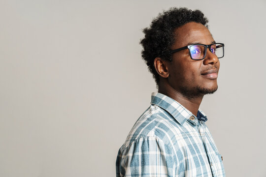 Young black man wearing eyeglasses posing and looking aside
