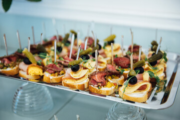 A wide variety of snacks on the table for guests. Shrimp, boiled pork, various types of meat and other products