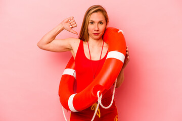 Young caucasian life guard woman isolated on pink background feels proud and self confident,...