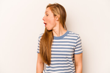 Young caucasian woman isolated on white background looks aside smiling, cheerful and pleasant.