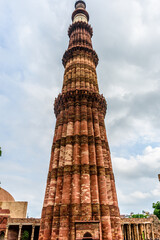 Fototapeta na wymiar Qutub (Qutb) Minar, the tallest free-standing stone tower in the world, and the tallest minaret in India, constructed with red sandstone and marble in 1199 AD. Unesco World Heritage. India