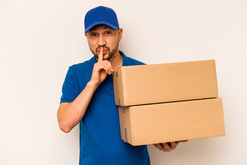 Hispanic delivery man isolated on white background keeping a secret or asking for silence.