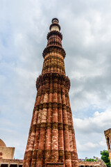 Fototapeta na wymiar Qutub (Qutb) Minar, the tallest free-standing stone tower in the world, and the tallest minaret in India, constructed with red sandstone and marble in 1199 AD. Unesco World Heritage. India