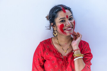 Happy young Bengali woman celebrates Sindur Khela tradition in Durga puja festival. Durga puja...