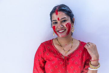 Happy young Bengali woman celebrates Sindur Khela tradition in Durga puja festival. Durga puja...