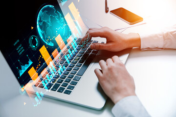 Businessman wearing formal wear typing on laptop sitting at office