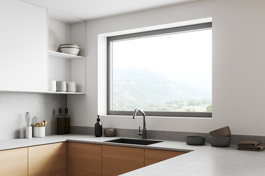 Corner view on bright kitchen room interior with window