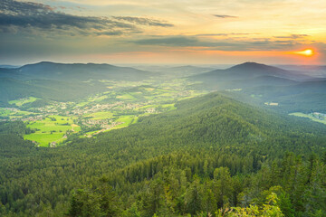 Golden hour view from mount Osser to Lam, a small town in the Bavarian Forest. Mount Hohenbogen on the right.