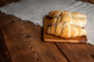 Freshly baked croissants on wooden background. Homemade croissants