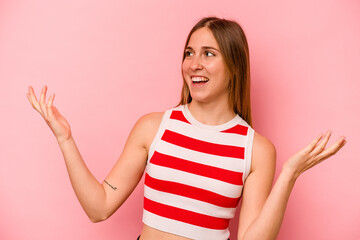 Young caucasian woman isolated on pink background joyful laughing a lot. Happiness concept.