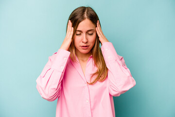 Young caucasian woman isolated on blue background touching temples and having headache.