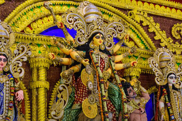 Goddess Durga idol at Durga Puja pandal in Kolkata, West Bengal, India. Durga Puja is one of the biggest religious festival of Hinduism - obrazy, fototapety, plakaty