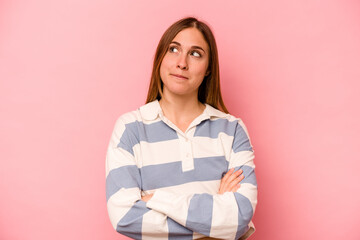 Fototapeta premium Young caucasian woman isolated on pink background dreaming of achieving goals and purposes