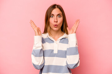 Young caucasian woman isolated on pink background surprised and shocked.