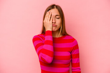 Young caucasian woman isolated on pink background tired and very sleepy keeping hand on head.