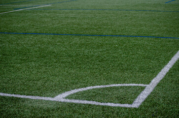 Corner line of a blue artificial turf football field