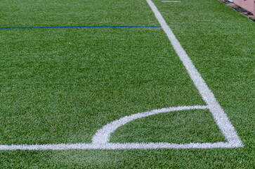 Obraz premium Corner line of a blue artificial turf soccer field