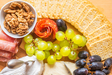 the cheese course on a wooden table, various types, cold buffet